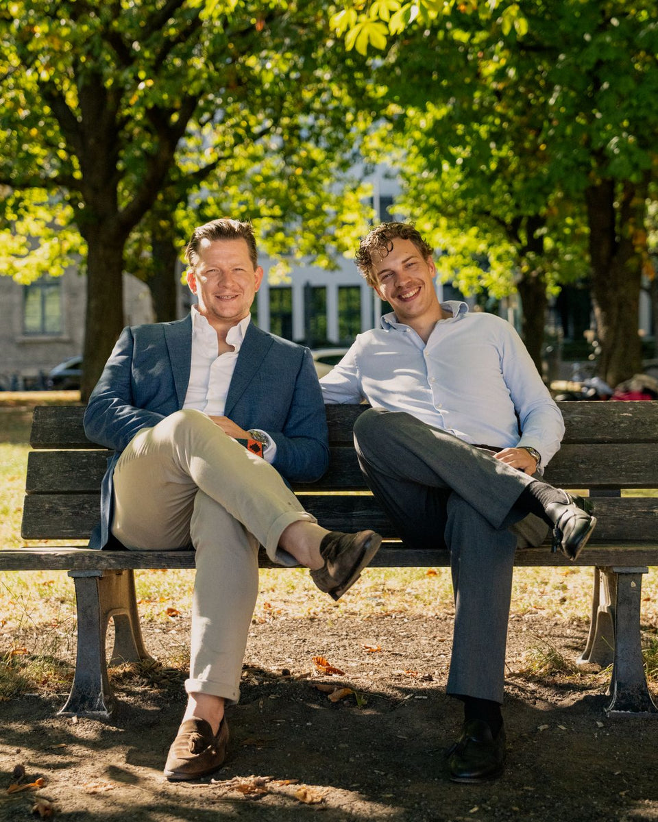 Sebastian Locher and Philipp Landwehr on a park bench in Munich